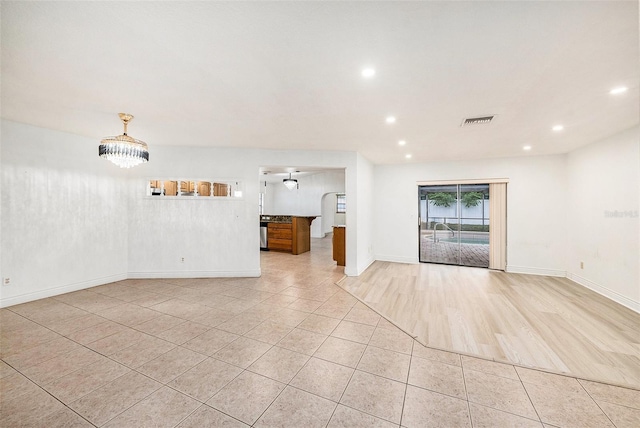 8744 Andros Ln, Port Richey, FL 34668 - unfurnished living room with light tile patterned floors, recessed lighting, and baseboards