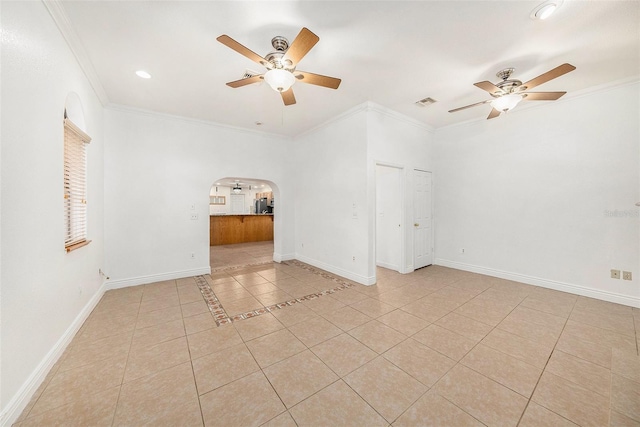 8744 Andros Ln, Port Richey, FL 34668 - spare room featuring ceiling fan, arched walkways, light tile patterned floors, ornamental molding, and baseboards