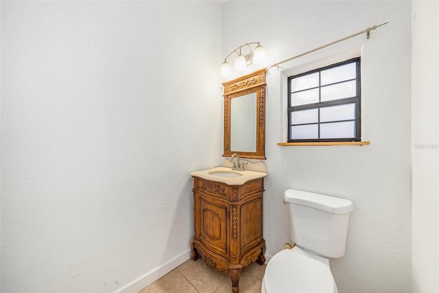 8744 Andros Ln, Port Richey, FL 34668 - bathroom featuring tile patterned floors, toilet, vanity, and baseboards