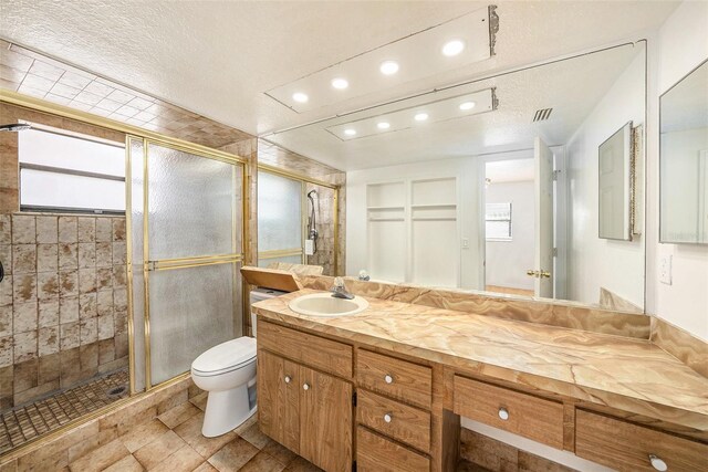 8744 Andros Ln, Port Richey, FL 34668 - full bathroom featuring a stall shower, recessed lighting, toilet, vanity, and a textured ceiling