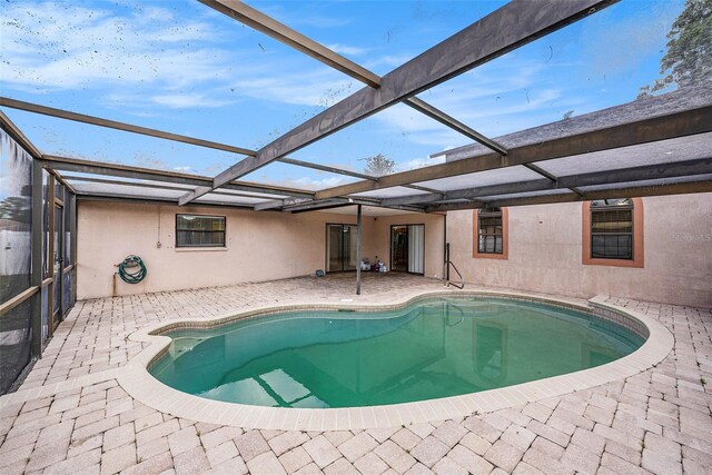 8744 Andros Ln, Port Richey, FL 34668 - swimming pool featuring a patio and glass enclosure