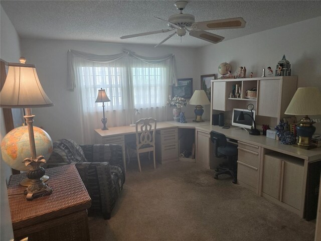 5705 80th St N Unit 303, Saint Petersburg, FL 33709 - office area featuring ceiling fan, built in desk, light colored carpet, and a textured ceiling