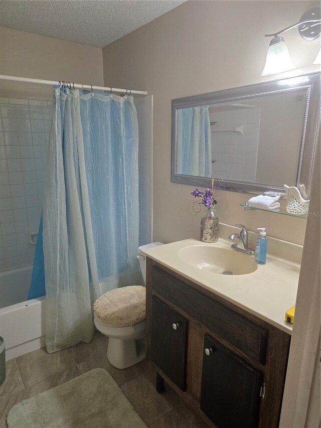 5705 80th St N Unit 303, Saint Petersburg, FL 33709 - full bath with toilet, vanity, shower / bathtub combination with curtain, a textured ceiling, and tile patterned flooring