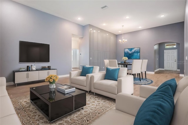 12420 Brick Cobblestone Dr, Riverview, FL 33579 - living room with arched walkways, a chandelier, light wood-style flooring, baseboards, and recessed lighting