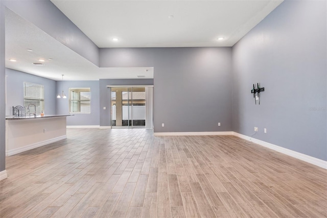12420 Brick Cobblestone Dr, Riverview, FL 33579 - unfurnished living room with baseboards, light wood-style floors, and recessed lighting