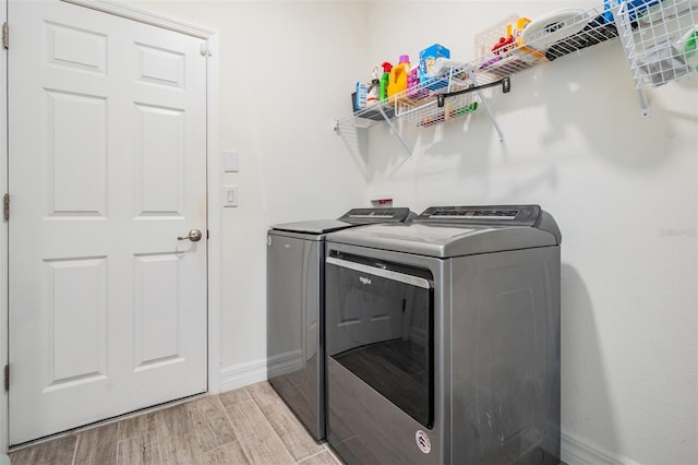 12420 Brick Cobblestone Dr, Riverview, FL 33579 - washroom featuring independent washer and dryer, light wood finished floors, and baseboards