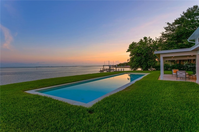 218 Colony Point Rd S, Saint Petersburg, FL 33705 - pool at dusk featuring a patio, a water view, and a yard