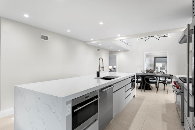 218 Colony Point Rd S, Saint Petersburg, FL 33705 - kitchen featuring modern cabinets, stainless steel appliances, a sink, a kitchen island with sink, and recessed lighting