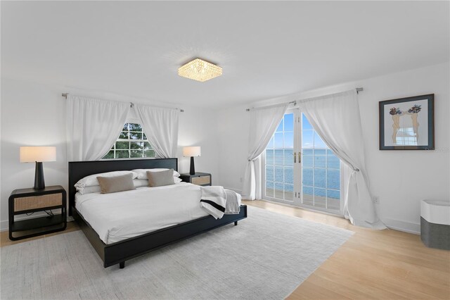 218 Colony Point Rd S, Saint Petersburg, FL 33705 - bedroom featuring a water view, access to outside, wood finished floors, and baseboards