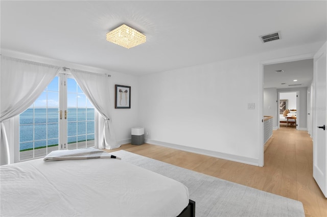 218 Colony Point Rd S, Saint Petersburg, FL 33705 - bedroom with a water view, light wood-type flooring, and baseboards