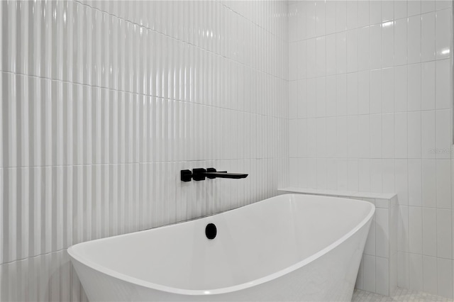 218 Colony Point Rd S, Saint Petersburg, FL 33705 - bathroom featuring tile walls and a freestanding bath