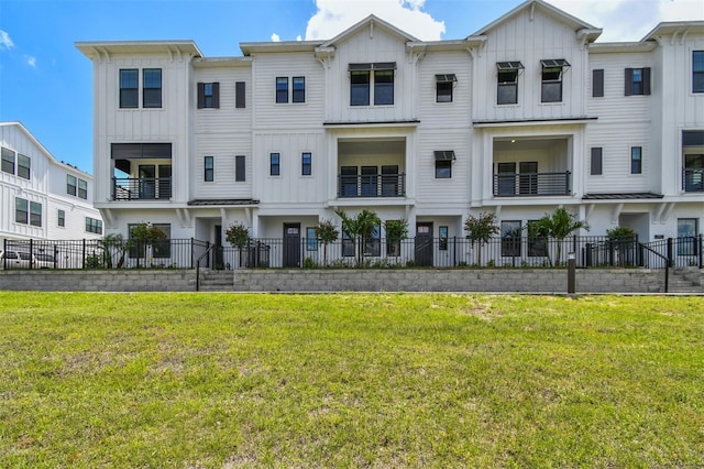 7240 Sutton Ln, Sarasota, FL 34240 - view of front facade featuring board and batten siding, a standing seam roof, and metal roof