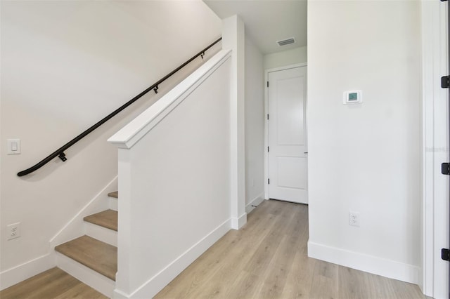 7240 Sutton Ln, Sarasota, FL 34240 - stairway featuring baseboards and wood finished floors
