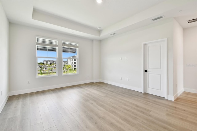 7240 Sutton Ln, Sarasota, FL 34240 - spare room featuring light wood-style flooring, baseboards, a tray ceiling, and recessed lighting
