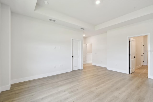 7240 Sutton Ln, Sarasota, FL 34240 - empty room with light wood-type flooring, recessed lighting, baseboards, a raised ceiling, and a smoke detector