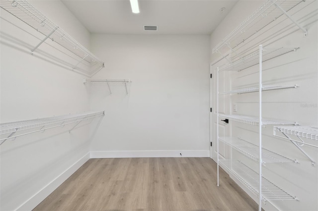 7240 Sutton Ln, Sarasota, FL 34240 - spacious closet featuring light wood-style flooring