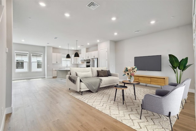7240 Sutton Ln, Sarasota, FL 34240 - living area with light wood-style floors, recessed lighting, and baseboards