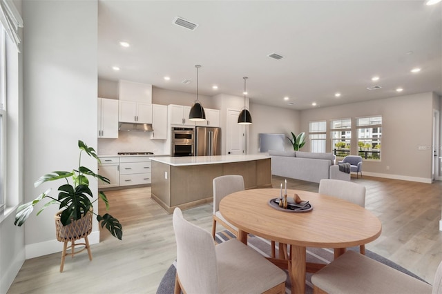 7240 Sutton Ln, Sarasota, FL 34240 - dining area with baseboards, light wood-type flooring, and recessed lighting