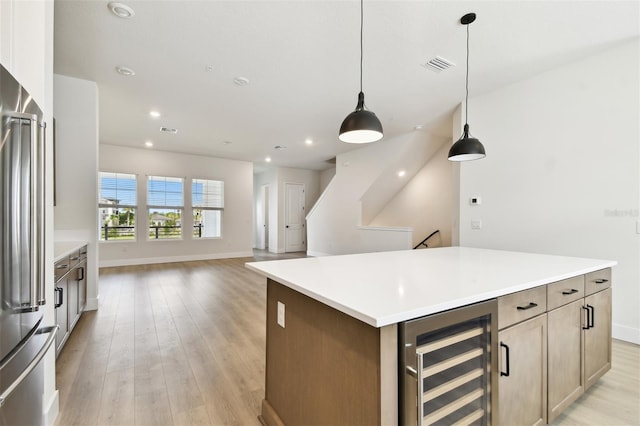 7240 Sutton Ln, Sarasota, FL 34240 - kitchen featuring wine cooler, stainless steel refrigerator, baseboards, light wood finished floors, and recessed lighting