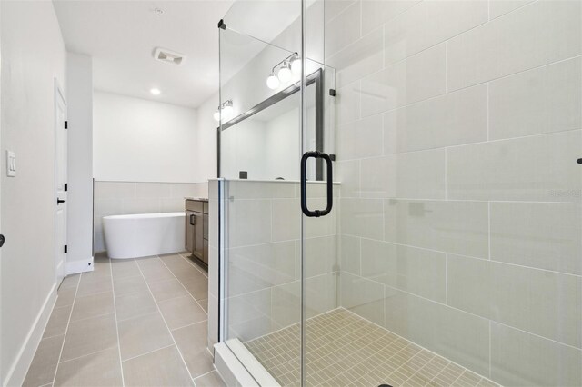 7240 Sutton Ln, Sarasota, FL 34240 - bathroom with a stall shower, vanity, tile patterned flooring, a freestanding tub, and recessed lighting