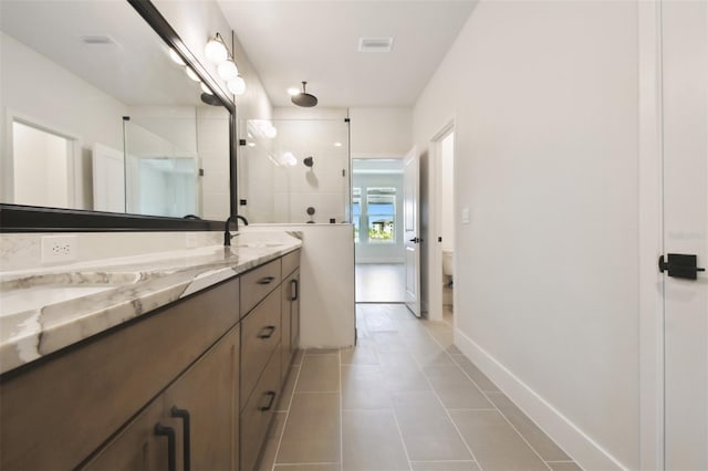7240 Sutton Ln, Sarasota, FL 34240 - bathroom featuring a tile shower, tile patterned flooring, double vanity, toilet, and baseboards