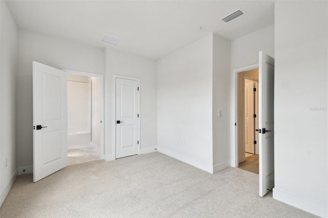 7240 Sutton Ln, Sarasota, FL 34240 - unfurnished bedroom featuring light colored carpet, baseboards, and ensuite bathroom
