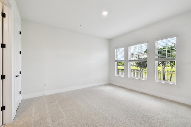 7240 Sutton Ln, Sarasota, FL 34240 - unfurnished room featuring baseboards and light carpet