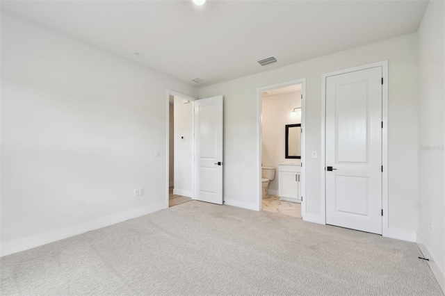 7240 Sutton Ln, Sarasota, FL 34240 - unfurnished bedroom with light colored carpet, baseboards, and ensuite bath