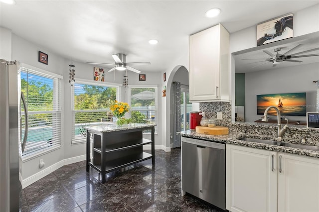 kitchen featuring appliances with stainless steel finishes, ceiling fan, a sink, baseboards, and recessed lighting