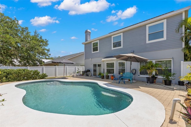 view of pool with a patio and fence