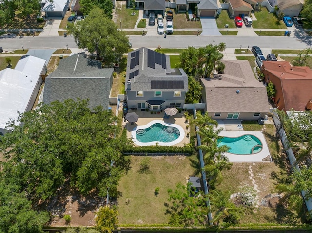 aerial perspective of suburban area featuring a pool