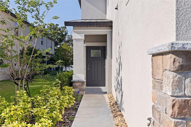 6542 95th Pl N, Pinellas Park, FL 33782 - property entrance with a standing seam roof, stucco siding, and metal roof