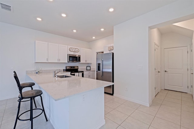 6542 95th Pl N, Pinellas Park, FL 33782 - kitchen featuring stainless steel appliances, a sink, a kitchen bar, a peninsula, and light stone counters