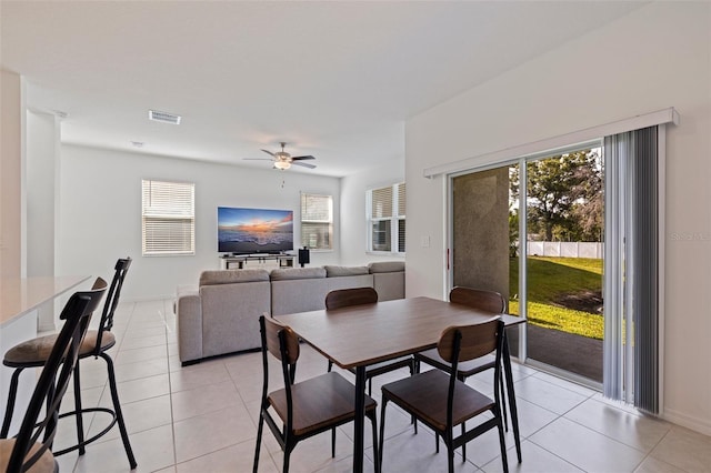 6542 95th Pl N, Pinellas Park, FL 33782 - dining room with light tile patterned flooring, a ceiling fan, and healthy amount of natural light