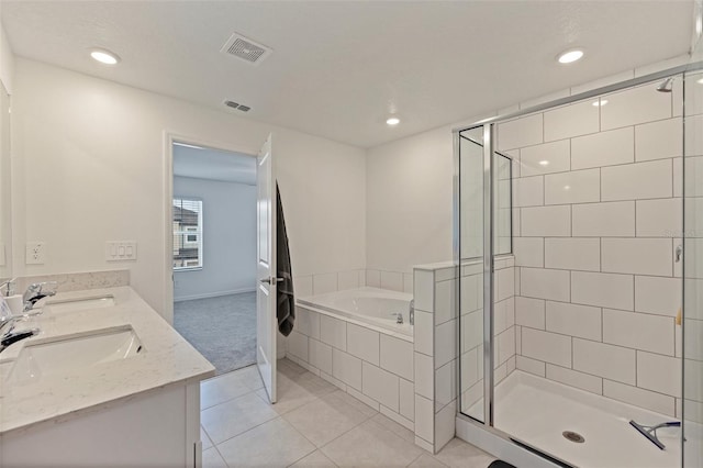 6542 95th Pl N, Pinellas Park, FL 33782 - bathroom featuring a garden tub, a stall shower, double vanity, tile patterned floors, and recessed lighting