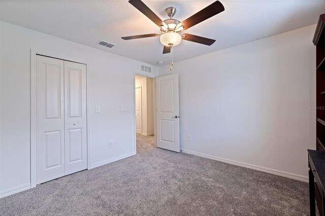 6542 95th Pl N, Pinellas Park, FL 33782 - unfurnished bedroom featuring carpet flooring, baseboards, a closet, and a ceiling fan