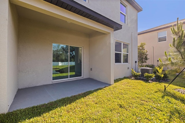 6542 95th Pl N, Pinellas Park, FL 33782 - back of house with stucco siding, a yard, a patio area, and cooling unit