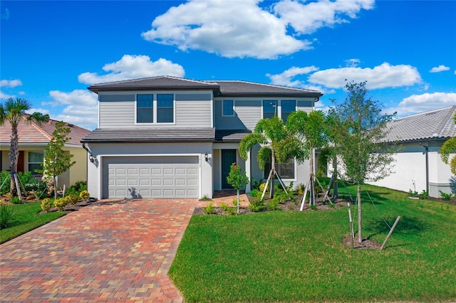 16117 Rosemallow Ln, Alva, FL 33920 - traditional home with decorative driveway, an attached garage, a front lawn, and stucco siding