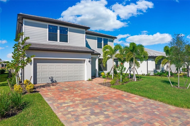 16117 Rosemallow Ln, Alva, FL 33920 - view of front of property featuring a garage, decorative driveway, a front yard, and stucco siding