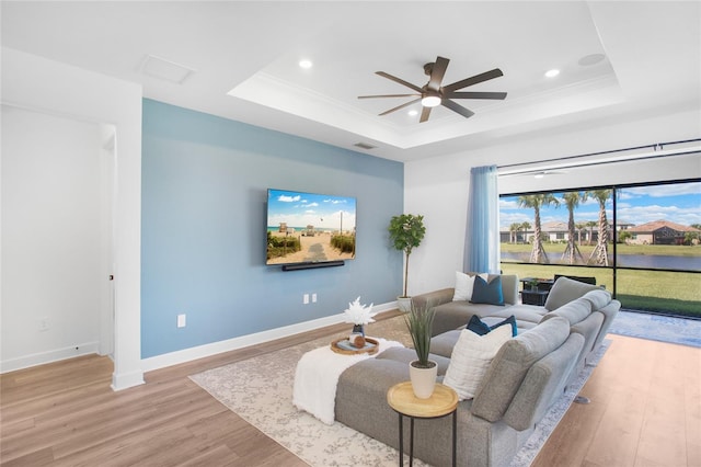 16117 Rosemallow Ln, Alva, FL 33920 - living room featuring a tray ceiling, a ceiling fan, wood finished floors, baseboards, and crown molding