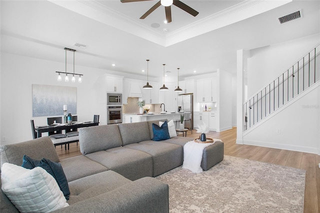 16117 Rosemallow Ln, Alva, FL 33920 - living area featuring a ceiling fan, light wood-style floors, ornamental molding, a raised ceiling, and recessed lighting