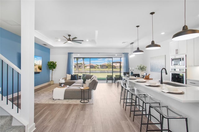 16117 Rosemallow Ln, Alva, FL 33920 - living room with light wood-style flooring, stairs, recessed lighting, ceiling fan, and a raised ceiling