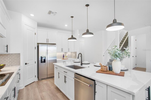 16117 Rosemallow Ln, Alva, FL 33920 - kitchen featuring stainless steel appliances, a sink, decorative backsplash, recessed lighting, and white cabinetry