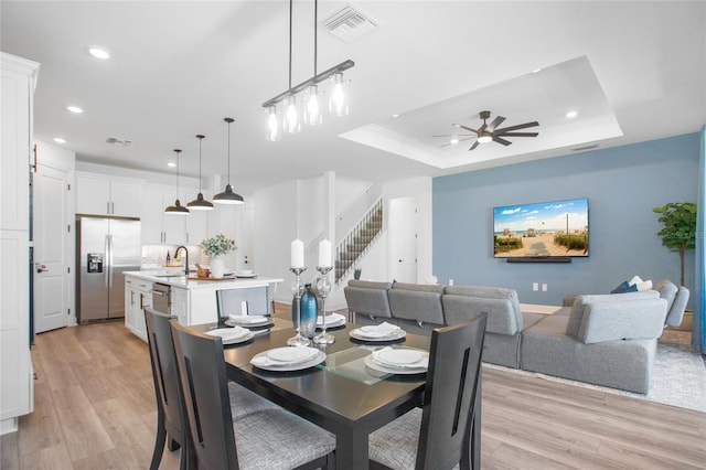 16117 Rosemallow Ln, Alva, FL 33920 - dining room with recessed lighting, light wood-type flooring, ceiling fan, a raised ceiling, and stairs