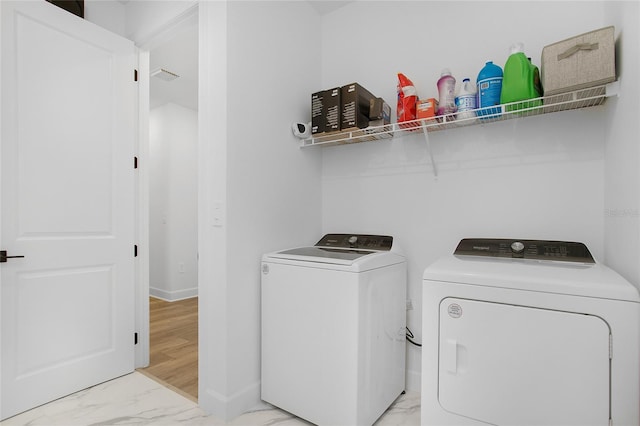 16117 Rosemallow Ln, Alva, FL 33920 - laundry room featuring washing machine and clothes dryer, light marble finish flooring, and baseboards