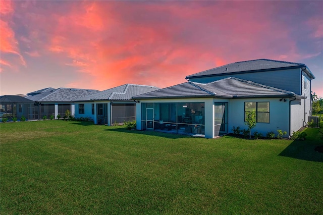 16117 Rosemallow Ln, Alva, FL 33920 - back of house featuring a lawn, a tiled roof, cooling unit, and a sunroom