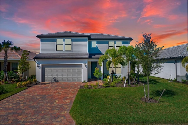 16117 Rosemallow Ln, Alva, FL 33920 - traditional home featuring decorative driveway, a garage, a lawn, and stucco siding