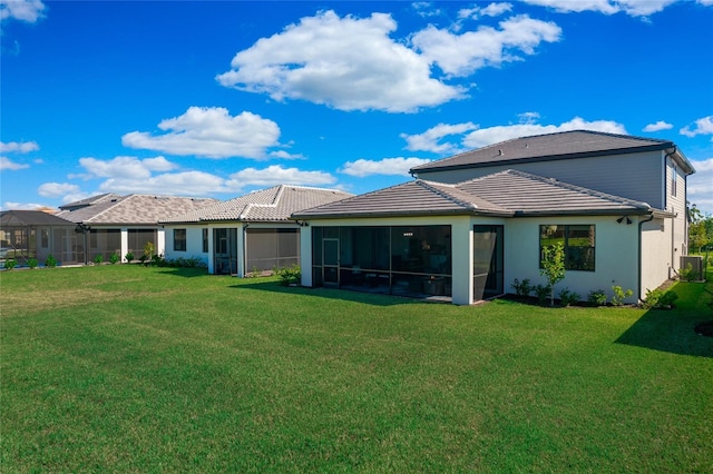 16117 Rosemallow Ln, Alva, FL 33920 - back of property featuring a lawn, a sunroom, central AC, and a tile roof