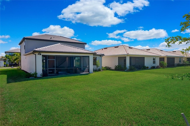 16117 Rosemallow Ln, Alva, FL 33920 - back of property with a sunroom, a lawn, and stucco siding