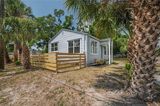 1527 E Lake Ave, Tampa, FL 33610 - view of side of home with fence and an outbuilding
